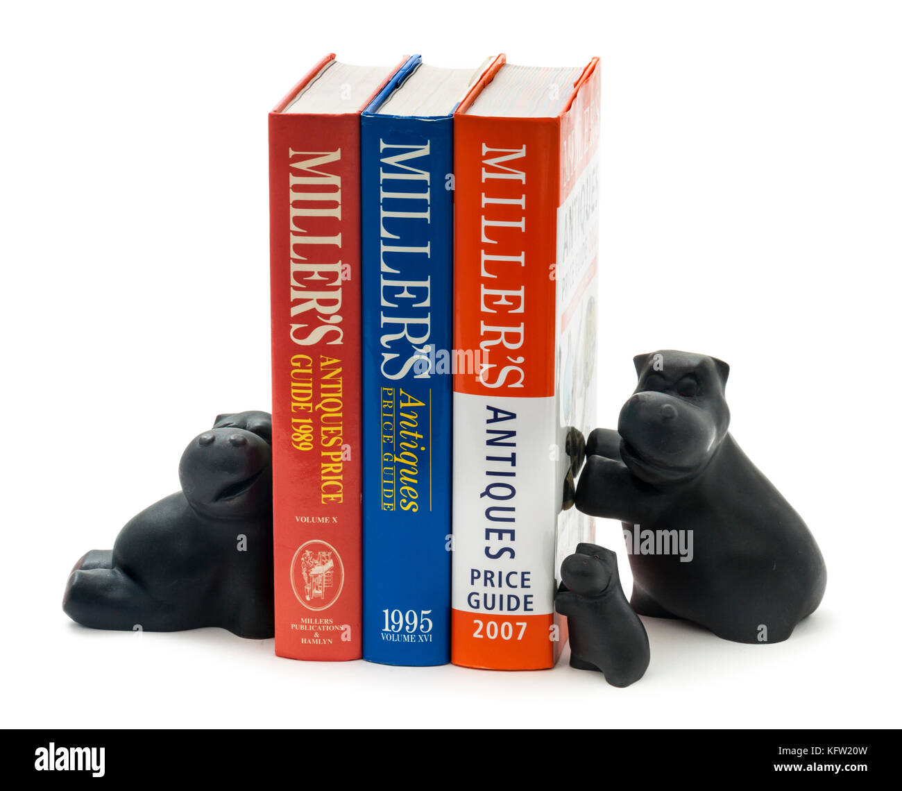Trio of unusual hippopotamus book stands, supporting a set of Miller's Antiques Price Guides Stock Photo