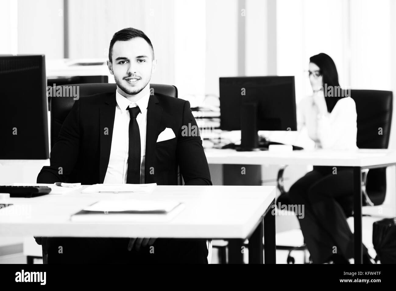 Happy Young Business Man And Woman Work In Modern Office On Computer Stock Photo