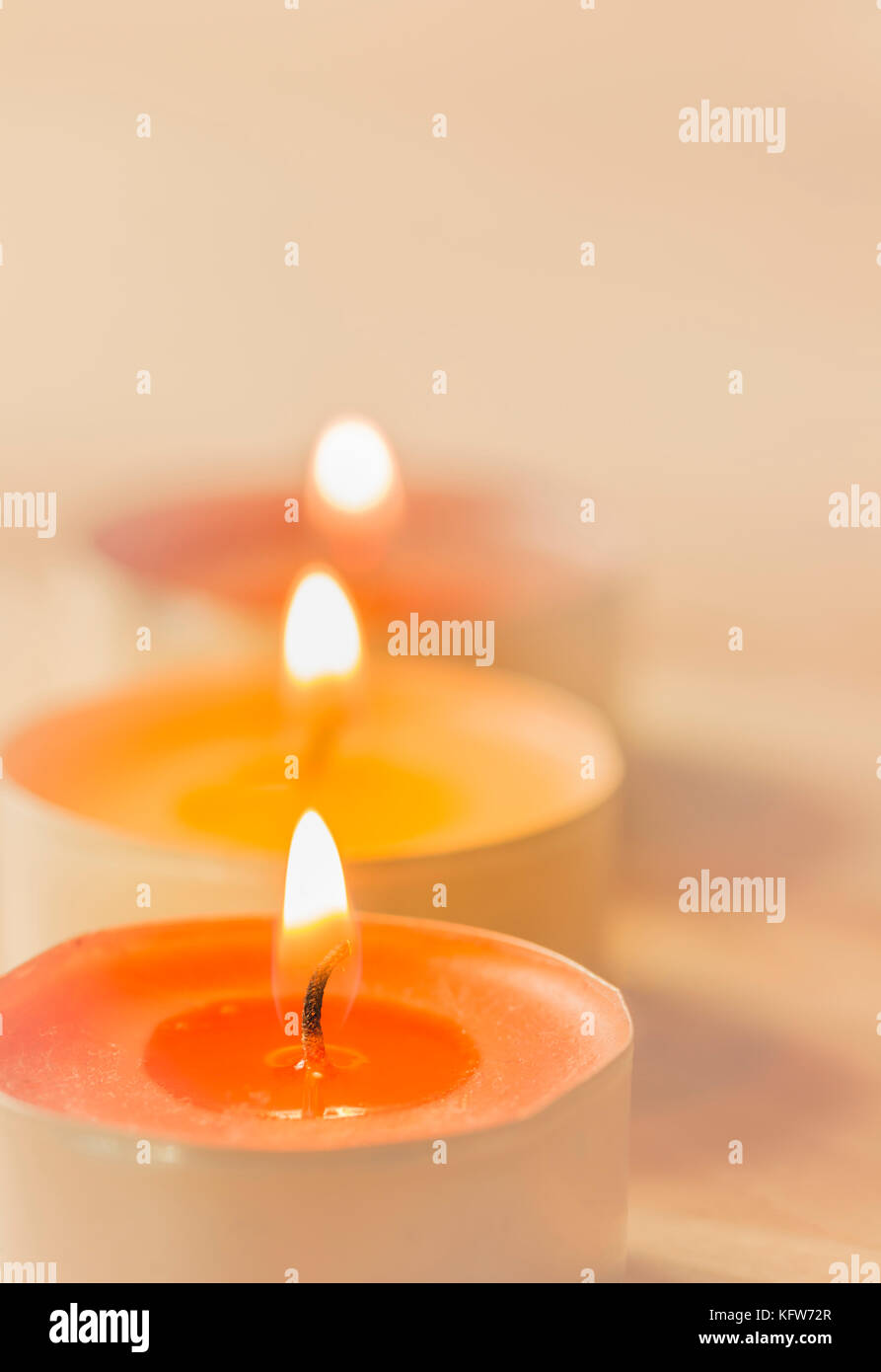 burning tea-lights with soft lights background Stock Photo