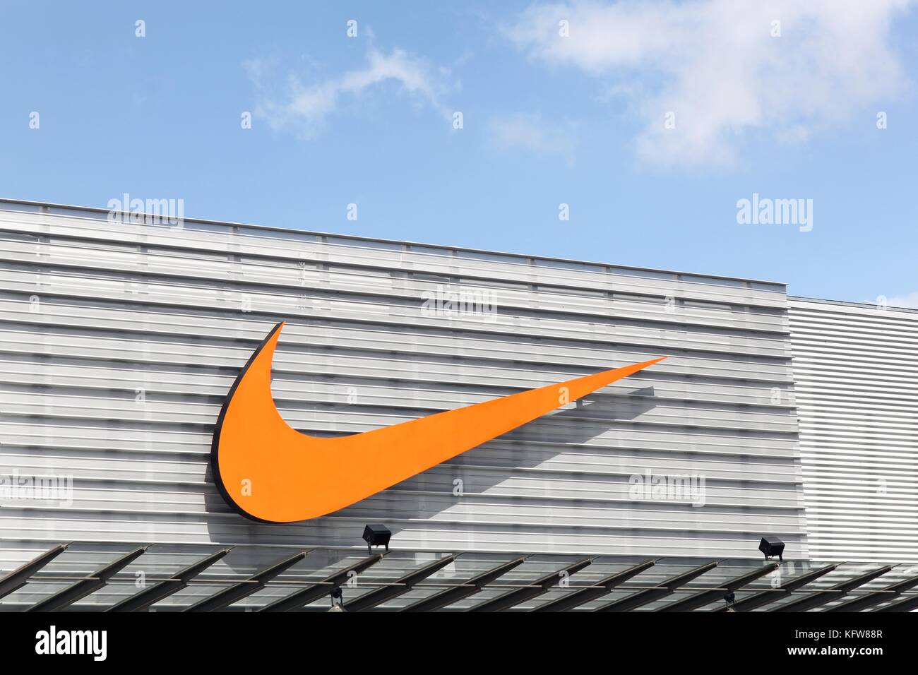 Bremen, Germany - July 2, 2017: Nike logo on a facade of a store. Nike is an American company specializing in sports equipment based in Beaverton Stock Photo