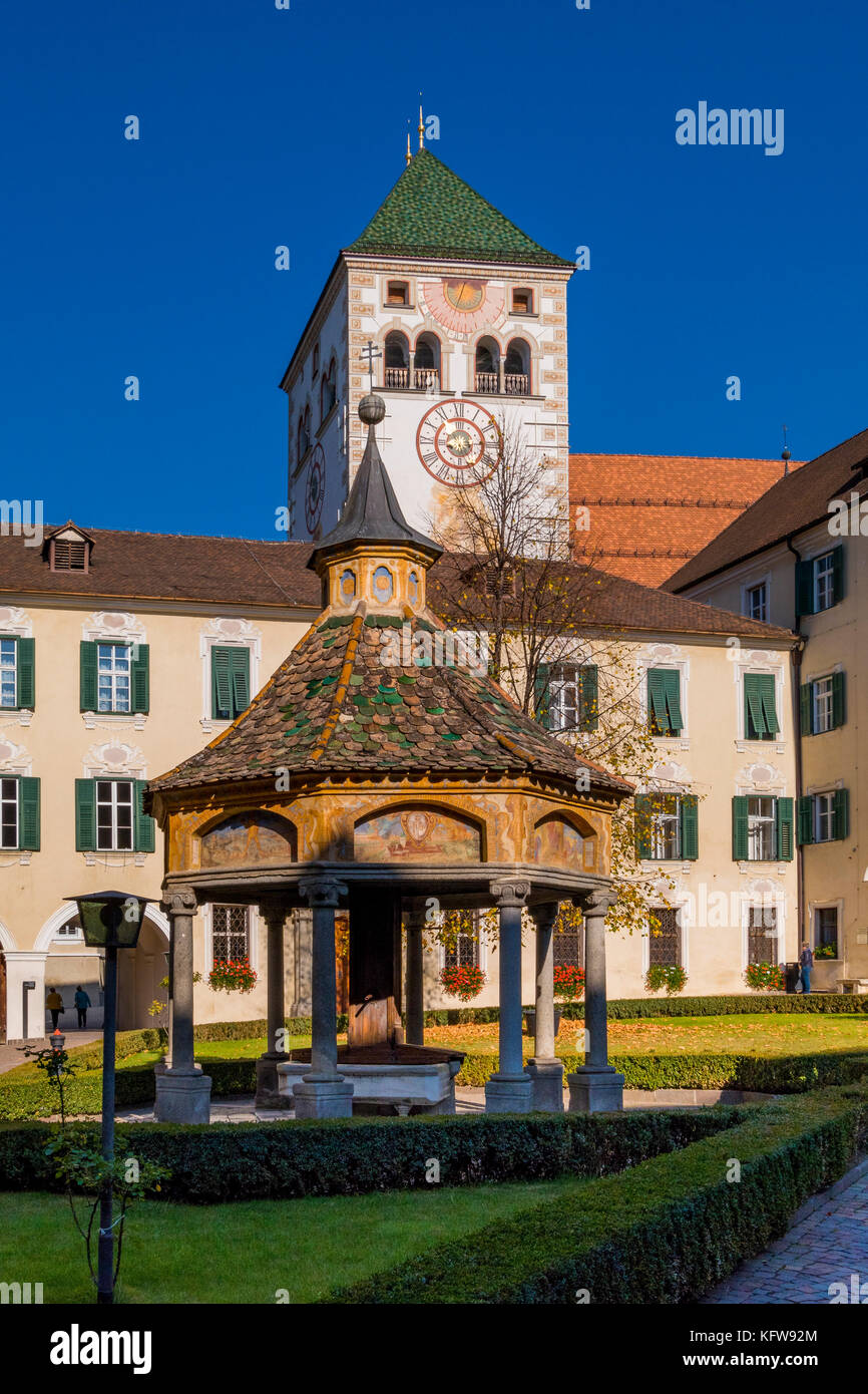Courtyard and the fountain Brunnen der Wunder (fountain of the wonders) with collegiate church in the Neustift Monastery near Brixen, South Tyrol, Ita Stock Photo