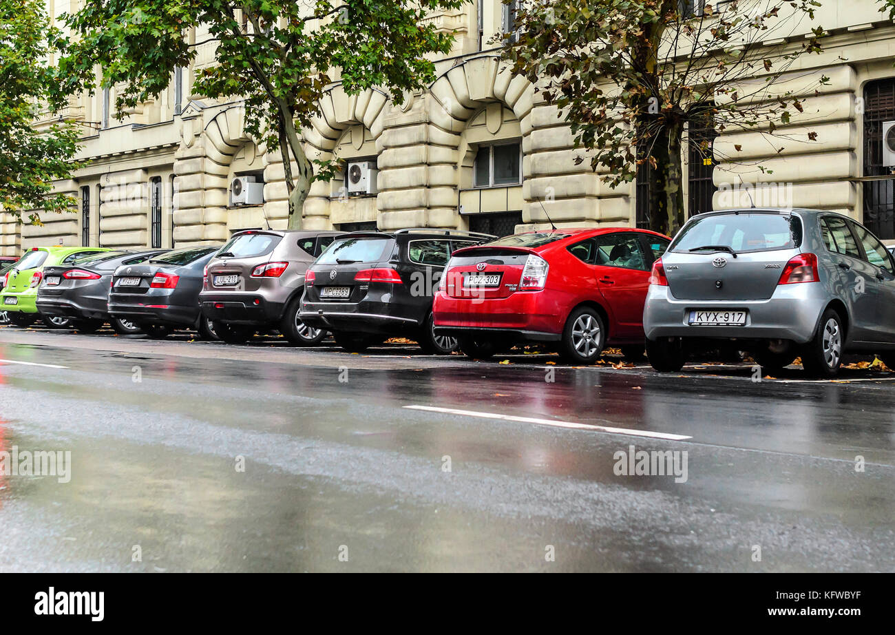 Cars in the street parking on a rainy day Stock Photo - Alamy
