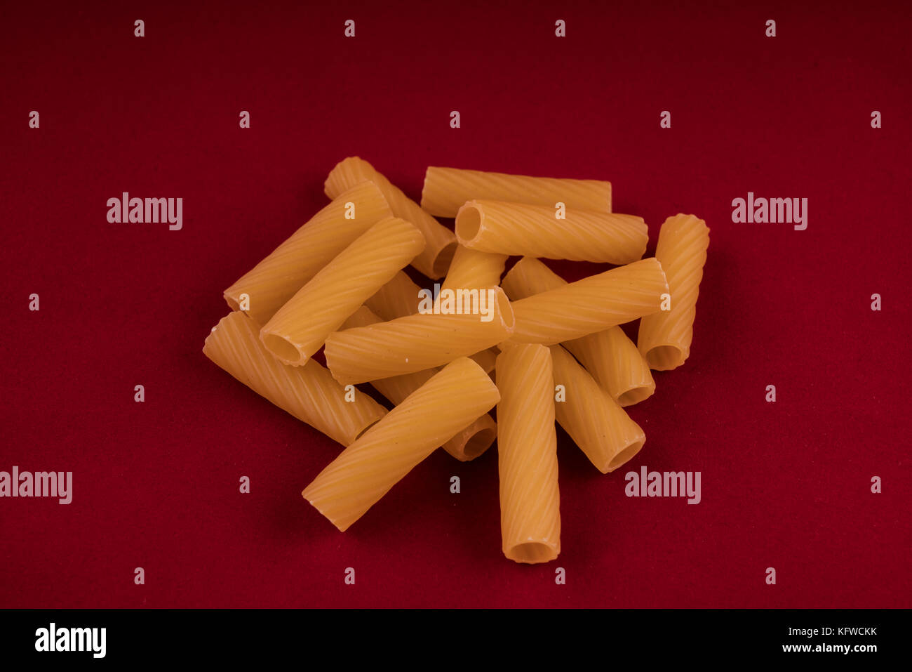 Italian rigatoni pasta on a red background Stock Photo Alamy