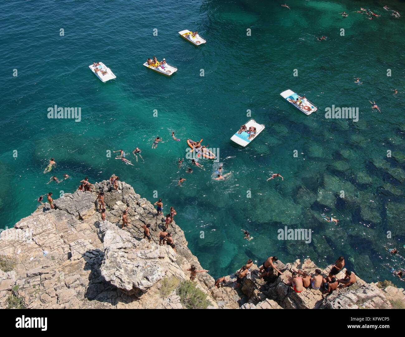 people swimming and on airbeds Polignano a Mare, Adriatic coastline, coastline, Puglia, Italy, Europe. Stock Photo