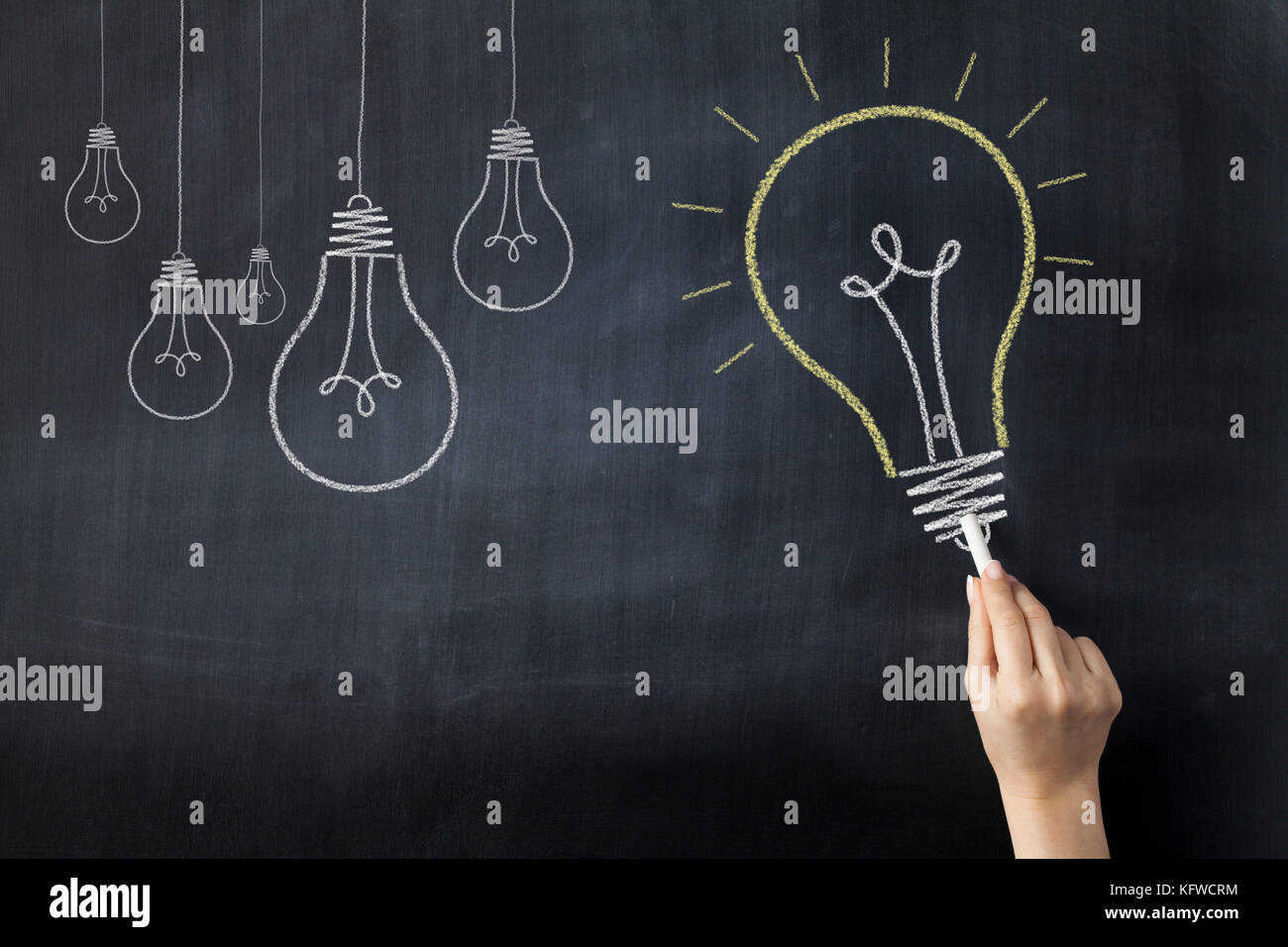 Hand drawing big light bulb on blackboard Stock Photo - Alamy