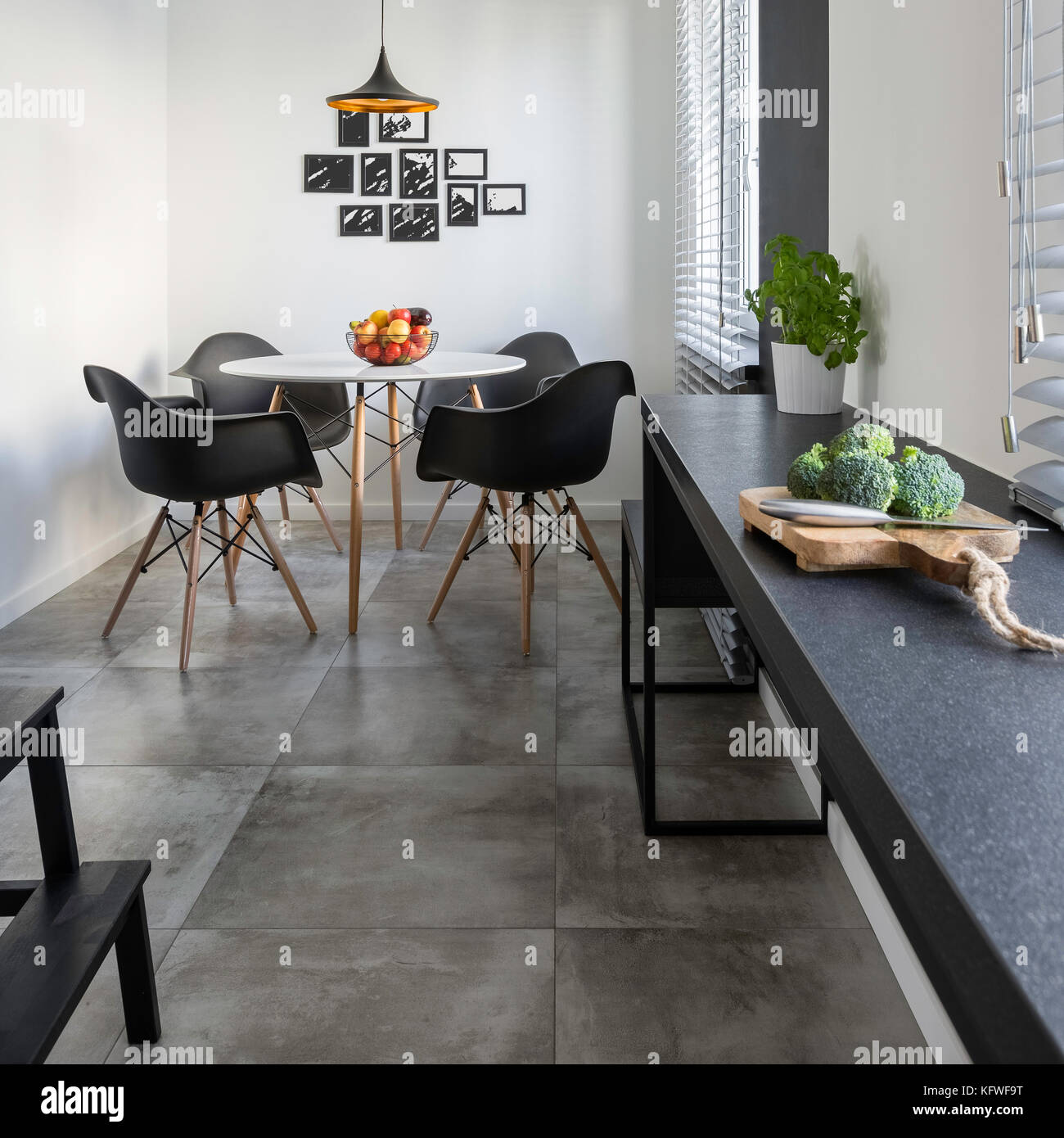 Kitchen With Long Granite Countertop Concrete Floor Tiles And