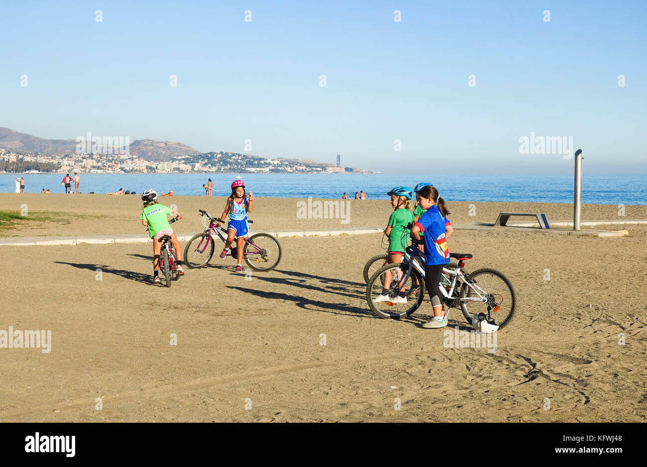 Young kids, sports, cycling on beach, Malaga, Andalusia, Spain. Stock Photo