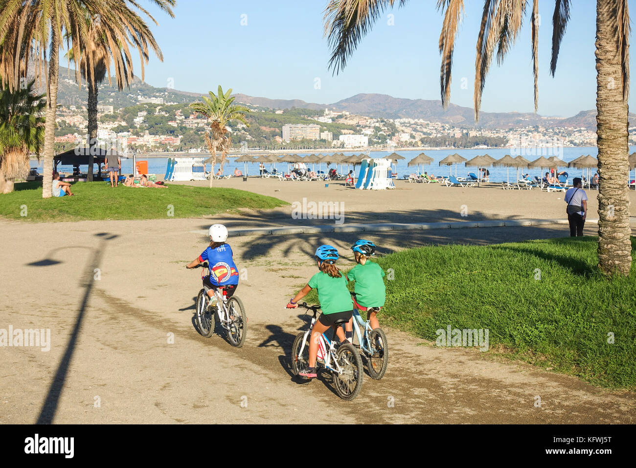 Young kids, sports, cycling on beach, Malaga, Andalusia, Spain. Stock Photo