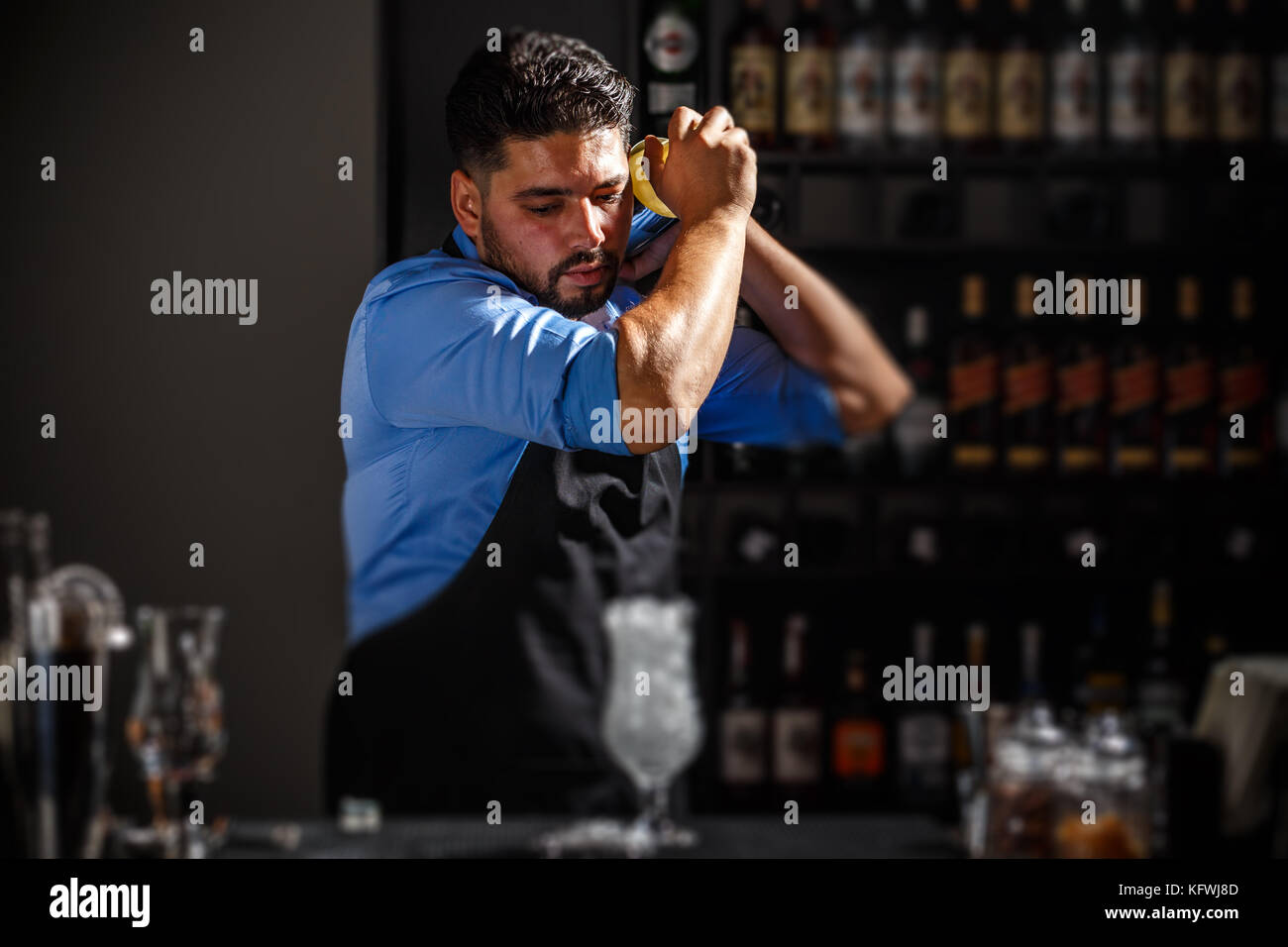 The bartender shakes and mixing alcohol cocktail Stock Photo