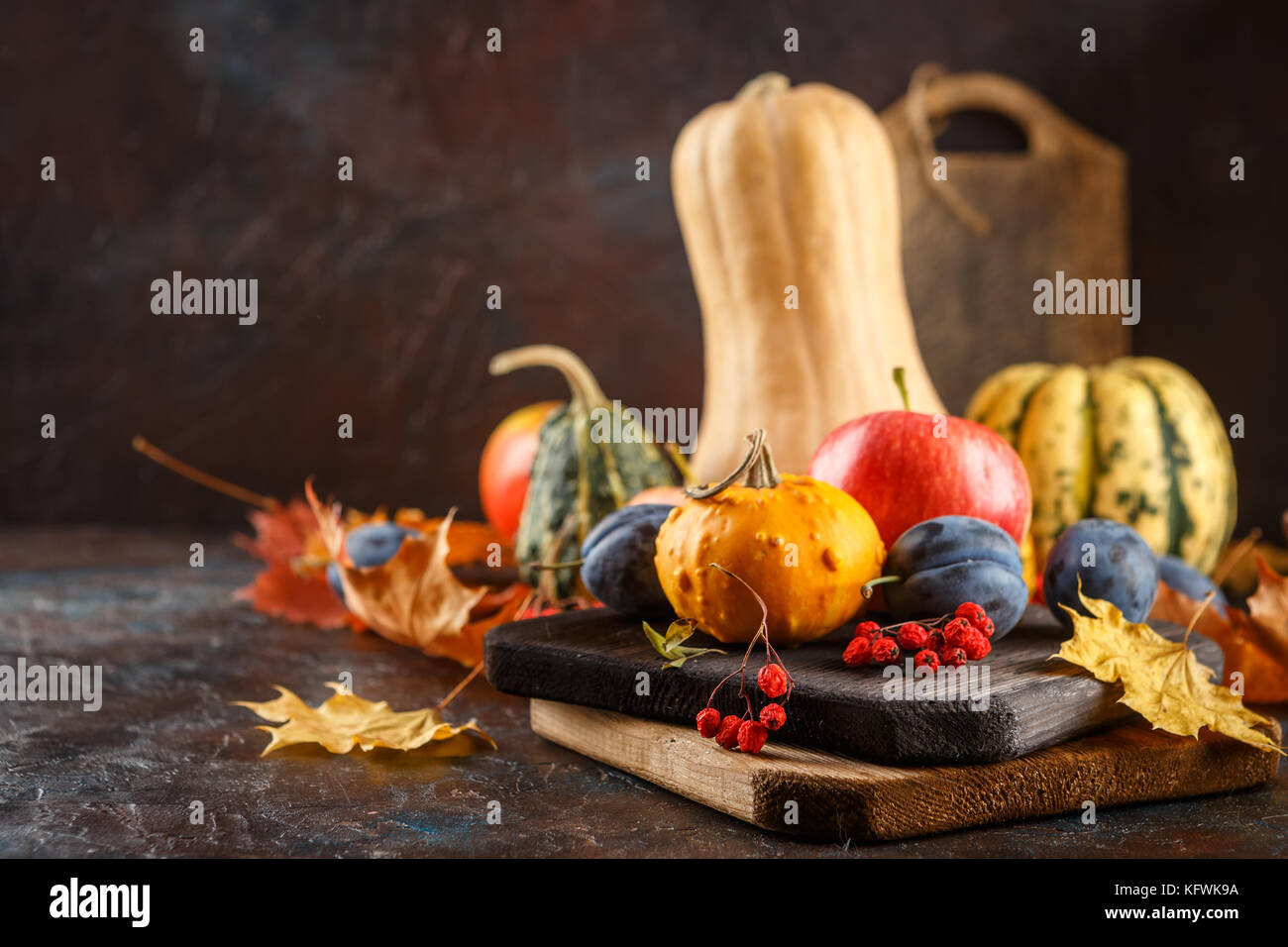Autumn still life with vegetables and fruits - pumpkins, apples, plums ...