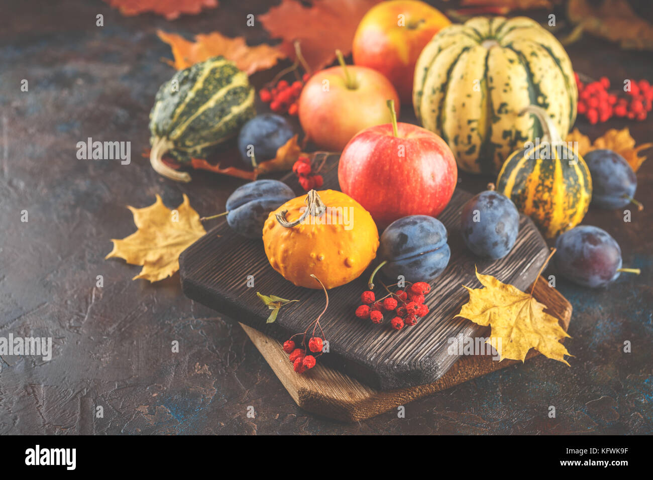 Autumn still life with vegetables and fruits - pumpkins, apples, plums ...