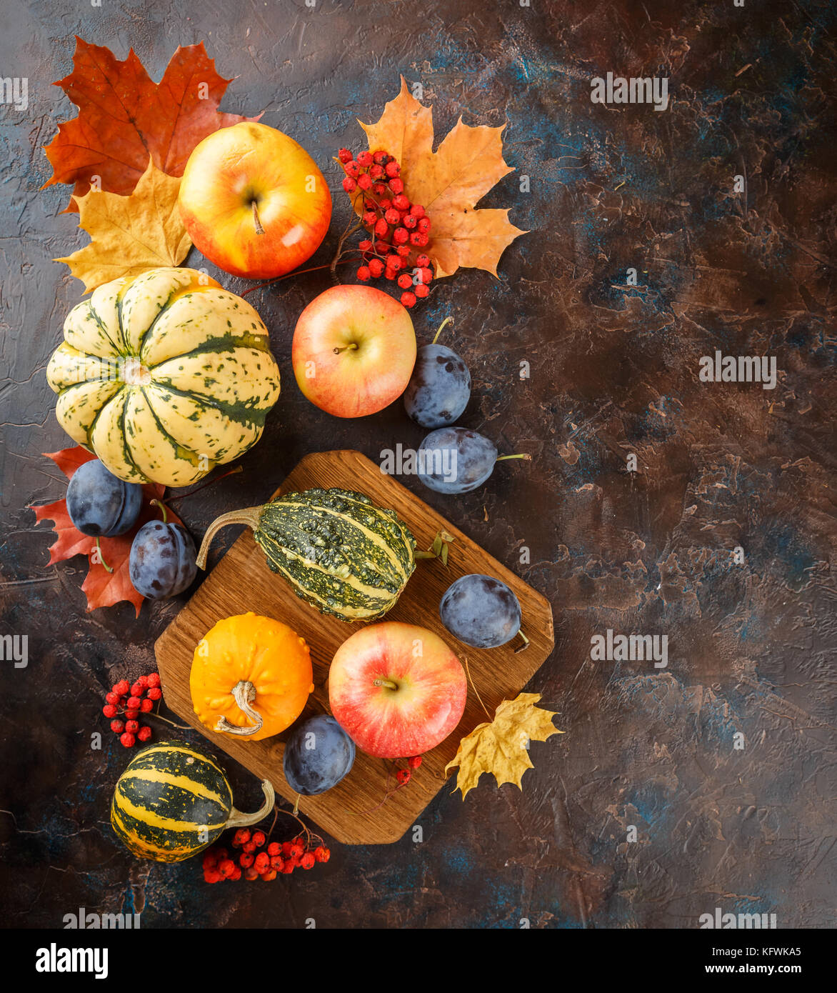 Autumn still life with vegetables and fruits - pumpkins, apples, plums ...