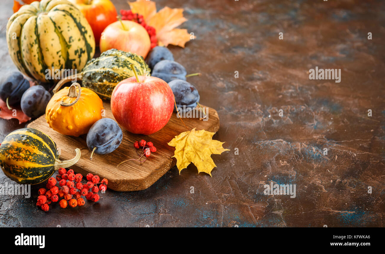 Autumn still life with vegetables and fruits - pumpkins, apples, plums ...