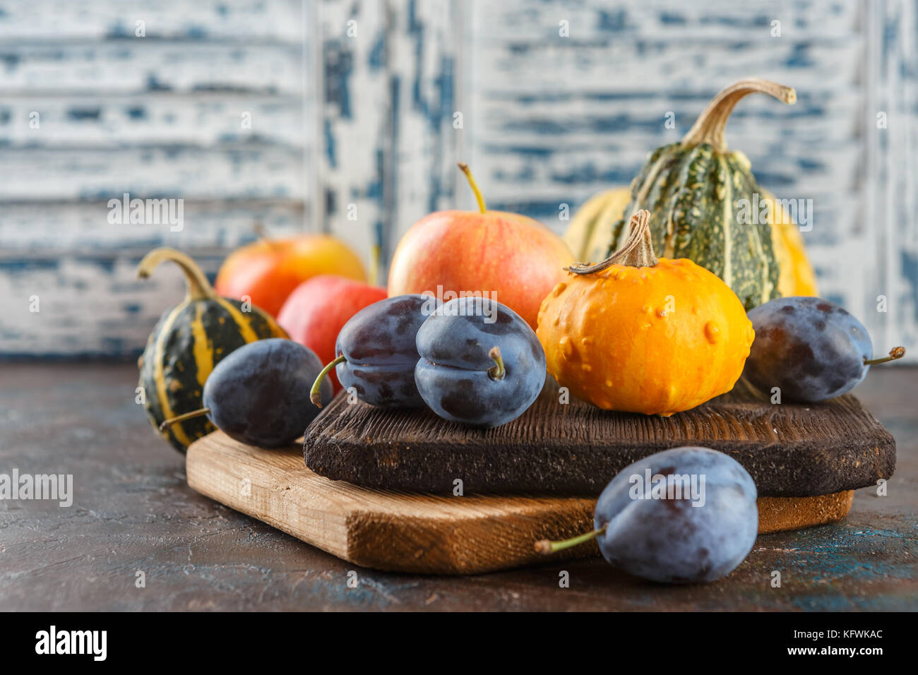 Autumn still life with vegetables and fruits - pumpkins, apples, plums ...