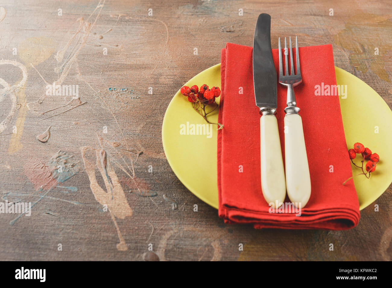 Autumn rustic table setting with berries, leaves and nuts. Free space for text. Stock Photo