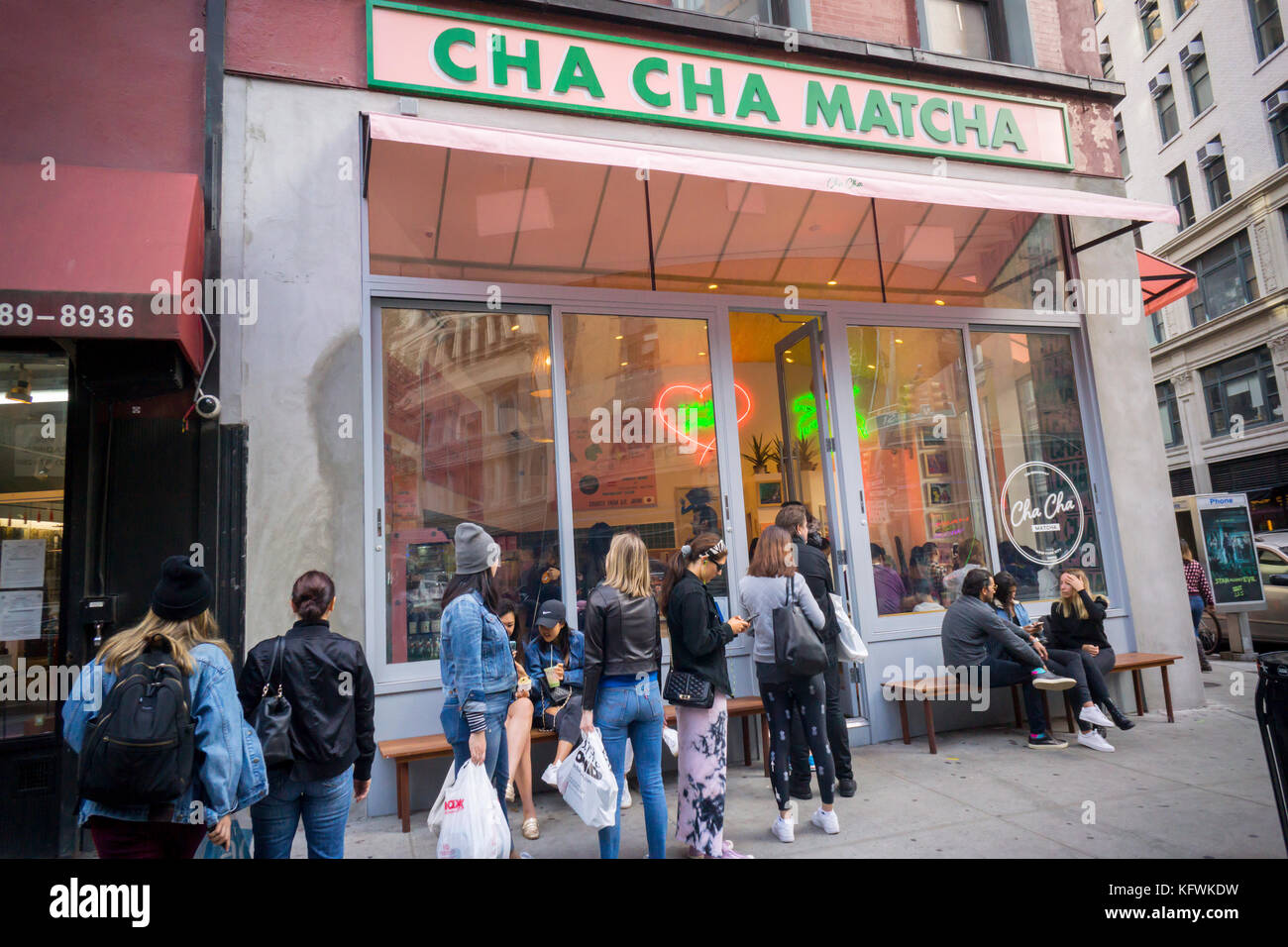 People line up for their fix of matcha at Cha Cha Matcha in the NoMad neighborhood of New York on Saturday, October 28, 2017. The popular beverage, matcha, is ground green tea and is used in Cha Cha Matcha to make instagramable beverages popular with millennials. Loaded with antioxidants matcha supposedly has medicinal qualities. (© Richard B. Levine) Stock Photo