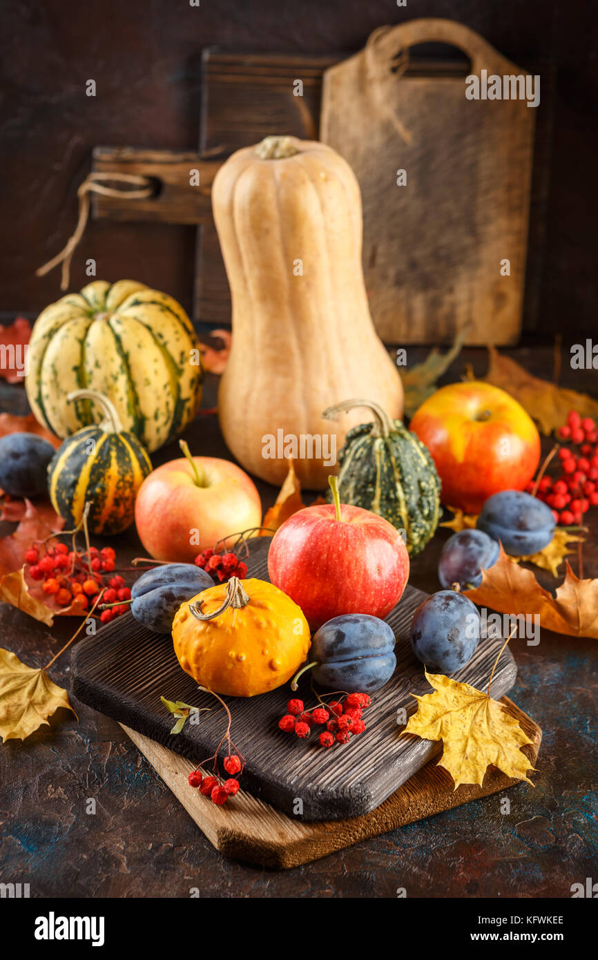 Autumn still life with vegetables and fruits - pumpkins, apples, plums ...