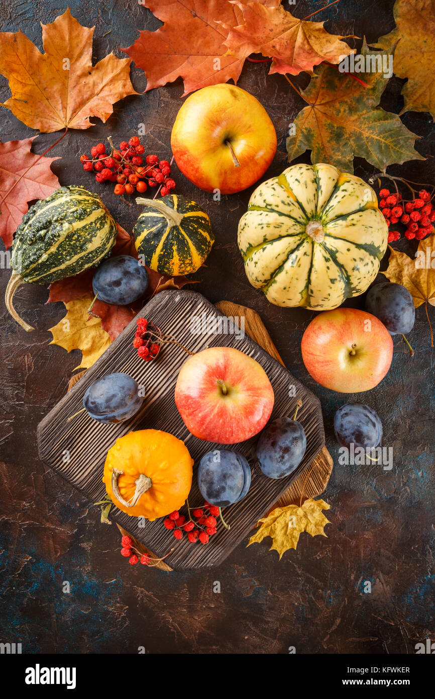 Autumn still life with vegetables and fruits - pumpkins, apples, plums ...