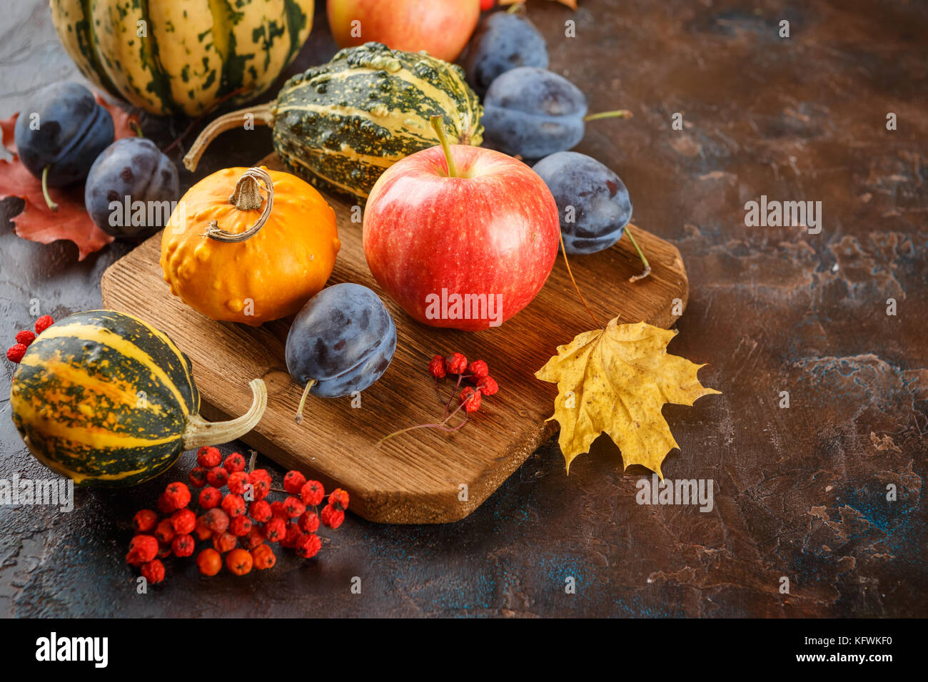 Autumn still life with vegetables and fruits - pumpkins, apples, plums ...