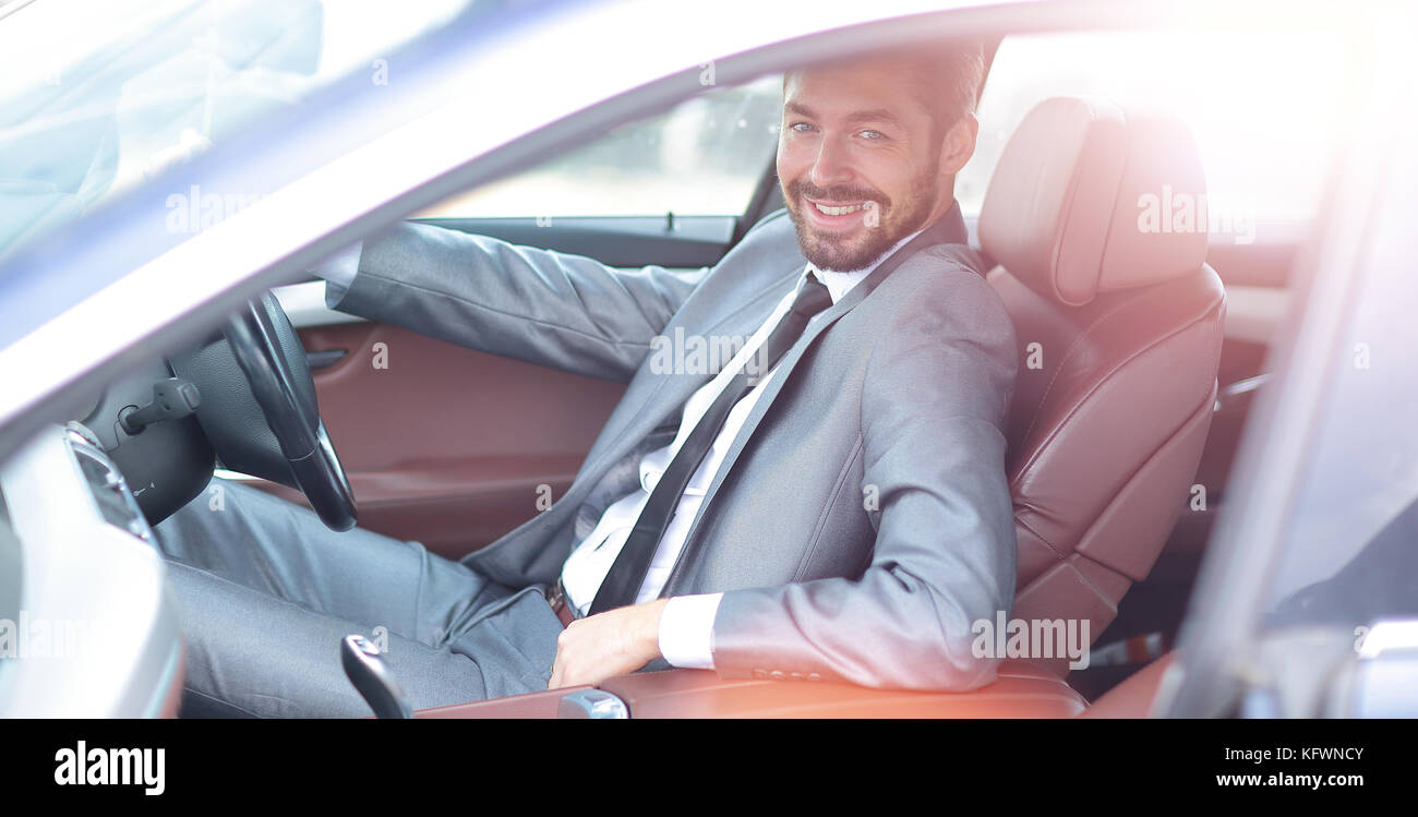 Portrait of an handsome smiling business man driving his car Stock ...