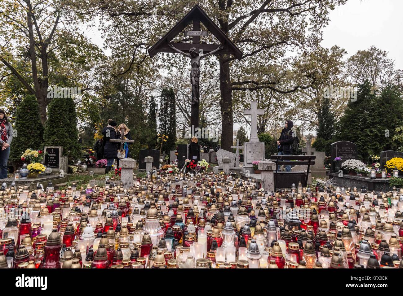 November 1, 2017 - Wroclaw, Poland - Polish people lays candles as they visit mass graves of their loved ones. All Saints' Day in Poland is dedicated to prayer and paying tribute to the deceased by visiting their graves. (Credit Image: © Krzysztof Kaniewski via ZUMA Wire) Stock Photo