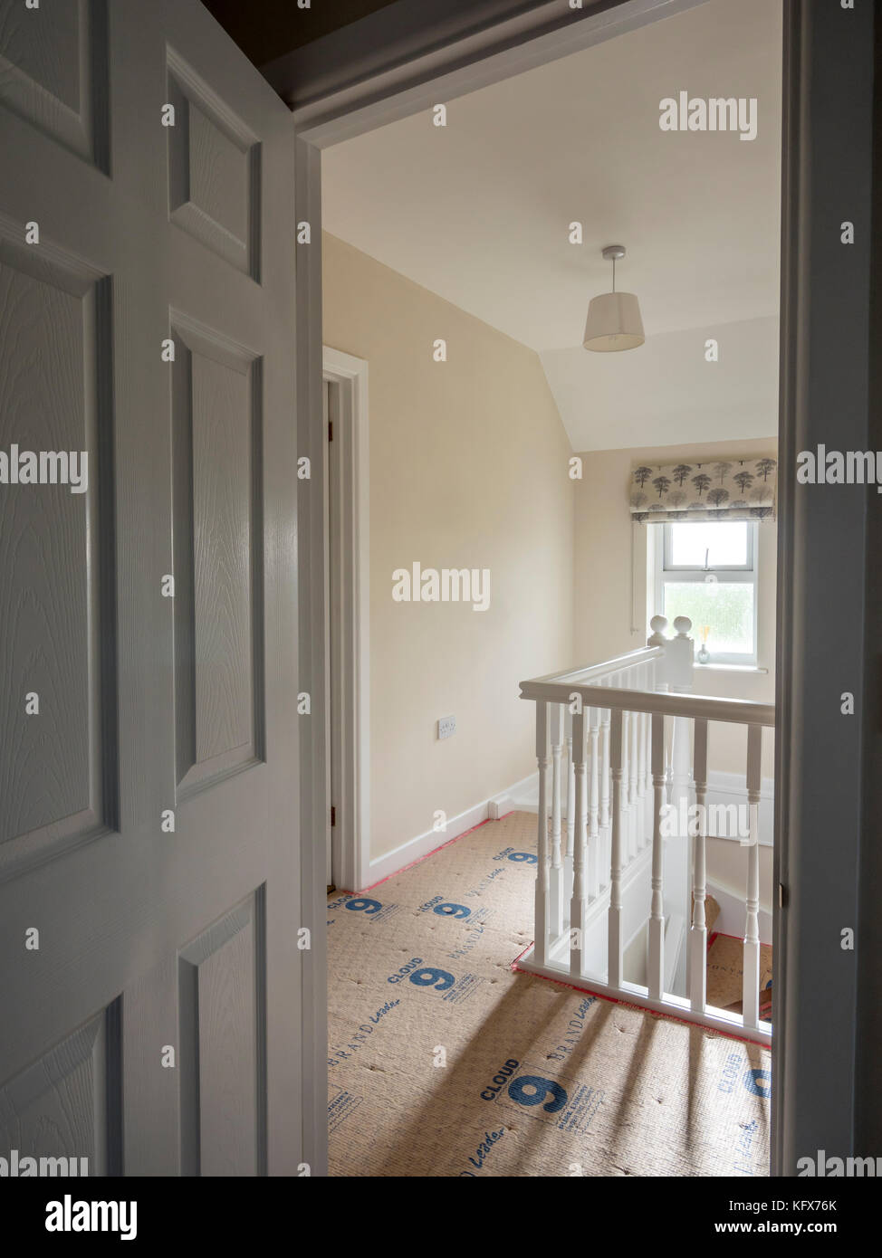 Newly decorated hallway with bare carpet underlay, ready for carpet