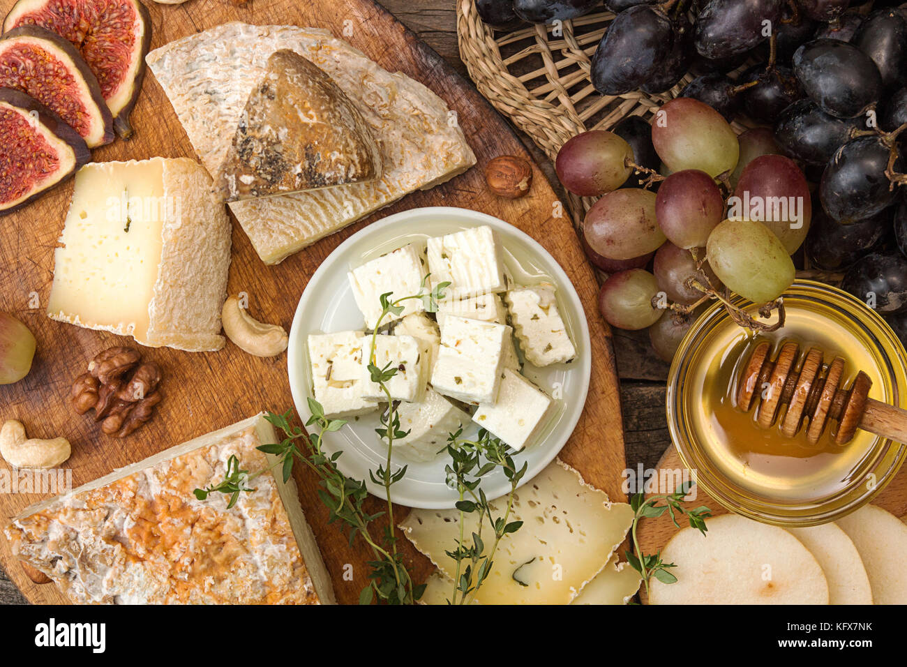 cheese plate with pieces moldy cheese, prosciutto, pickled plums