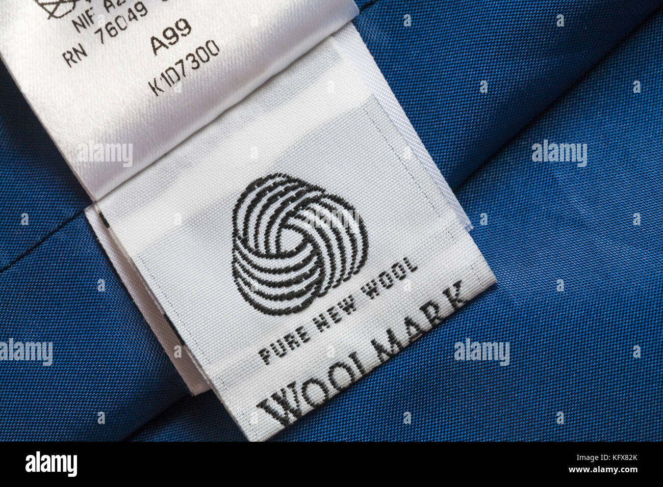 Woolmark pure new wool symbol on label in woman's blue suit clothing Stock Photo
