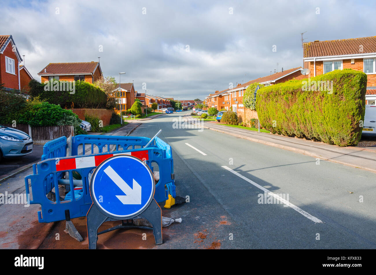 Temporary roadworks on St Andrews Drive in Perton, South Staffordshire near Wolverhampton to install fibre optic cables. Stock Photo
