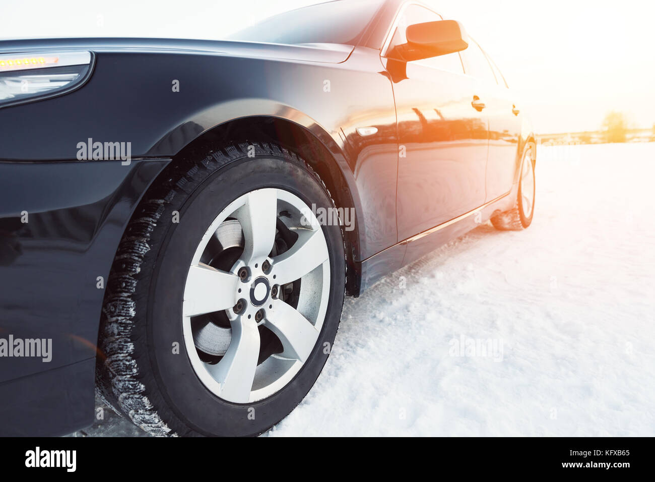 Close up of car tires on the winter road with snow Stock Photo - Alamy