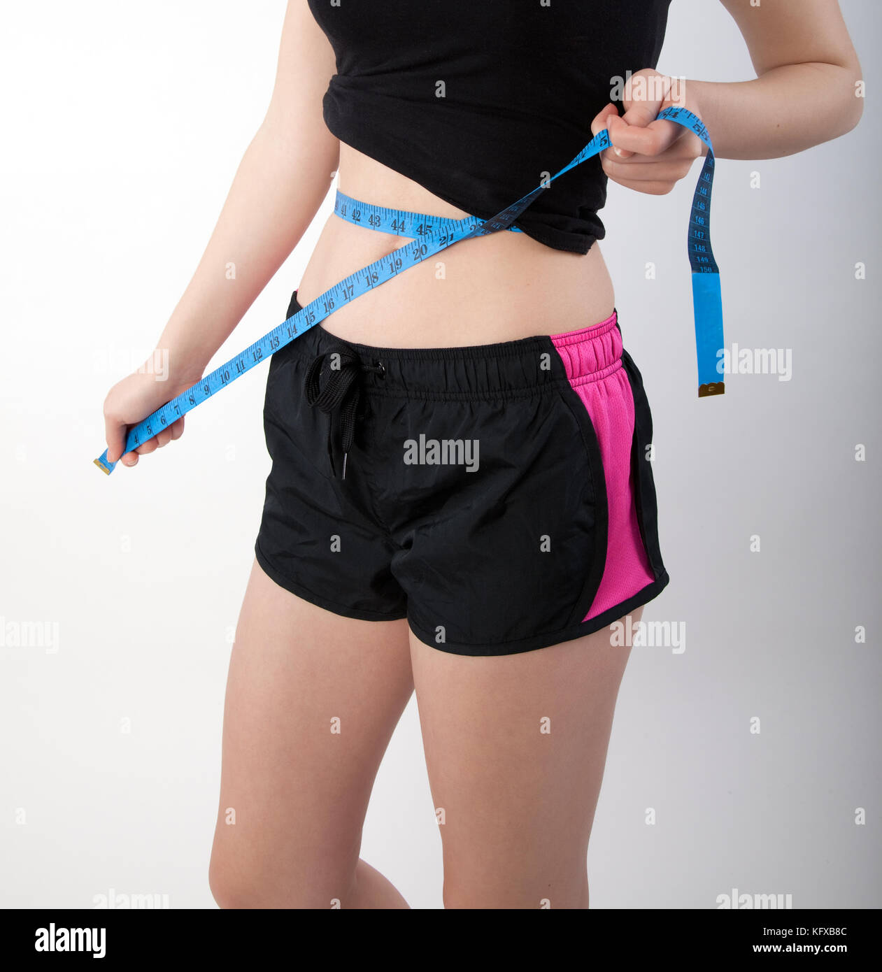 young woman measuring her body Stock Photo