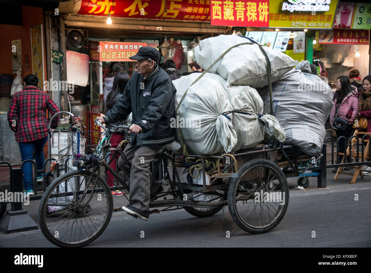 Man transporting goods on his tricycle Stock Photo