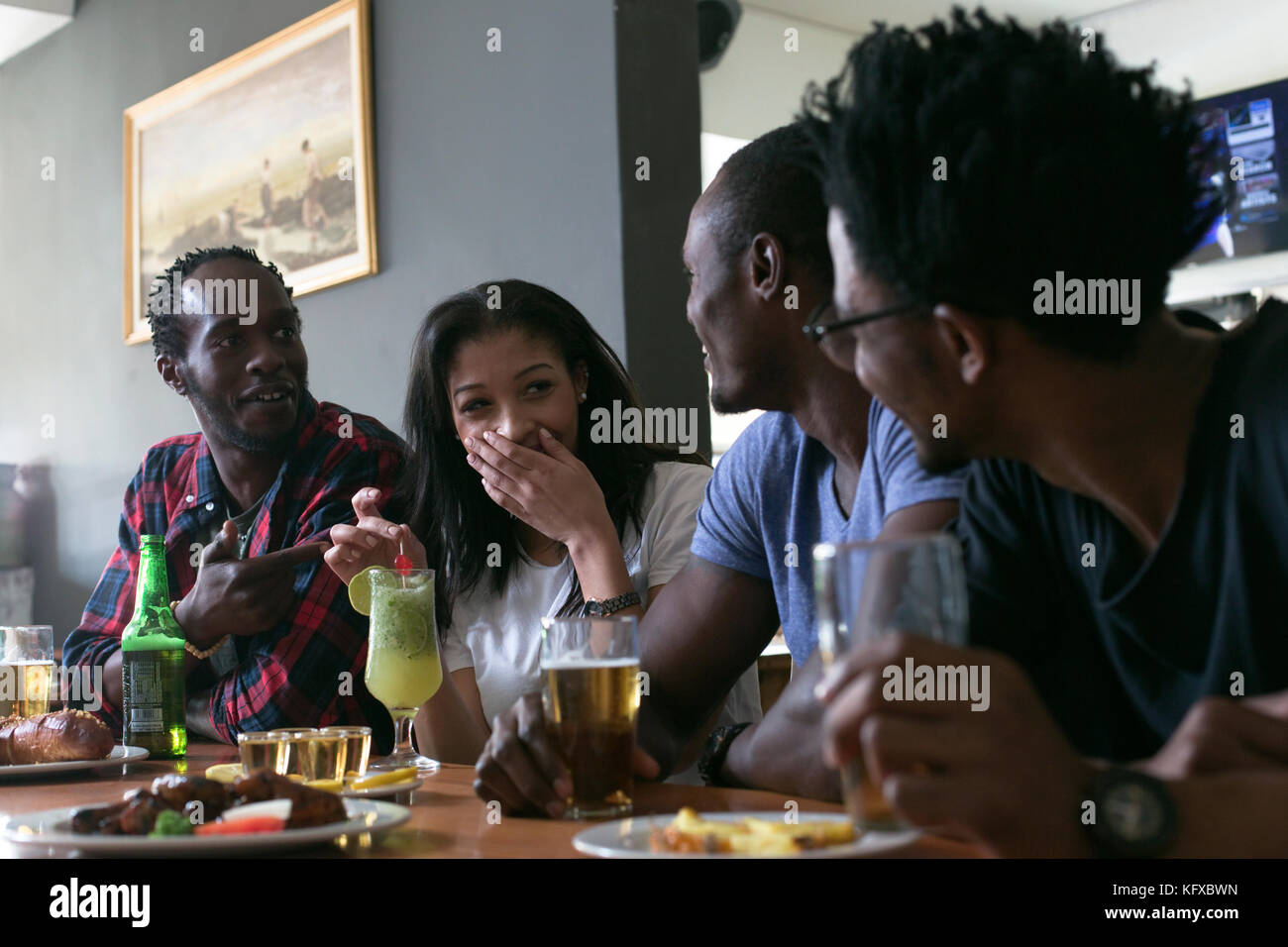 Friends socializing at a sports bar Stock Photo