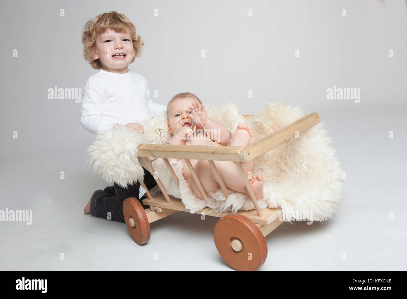 Two generation family studio portrait on grey and white background. Stock Photo