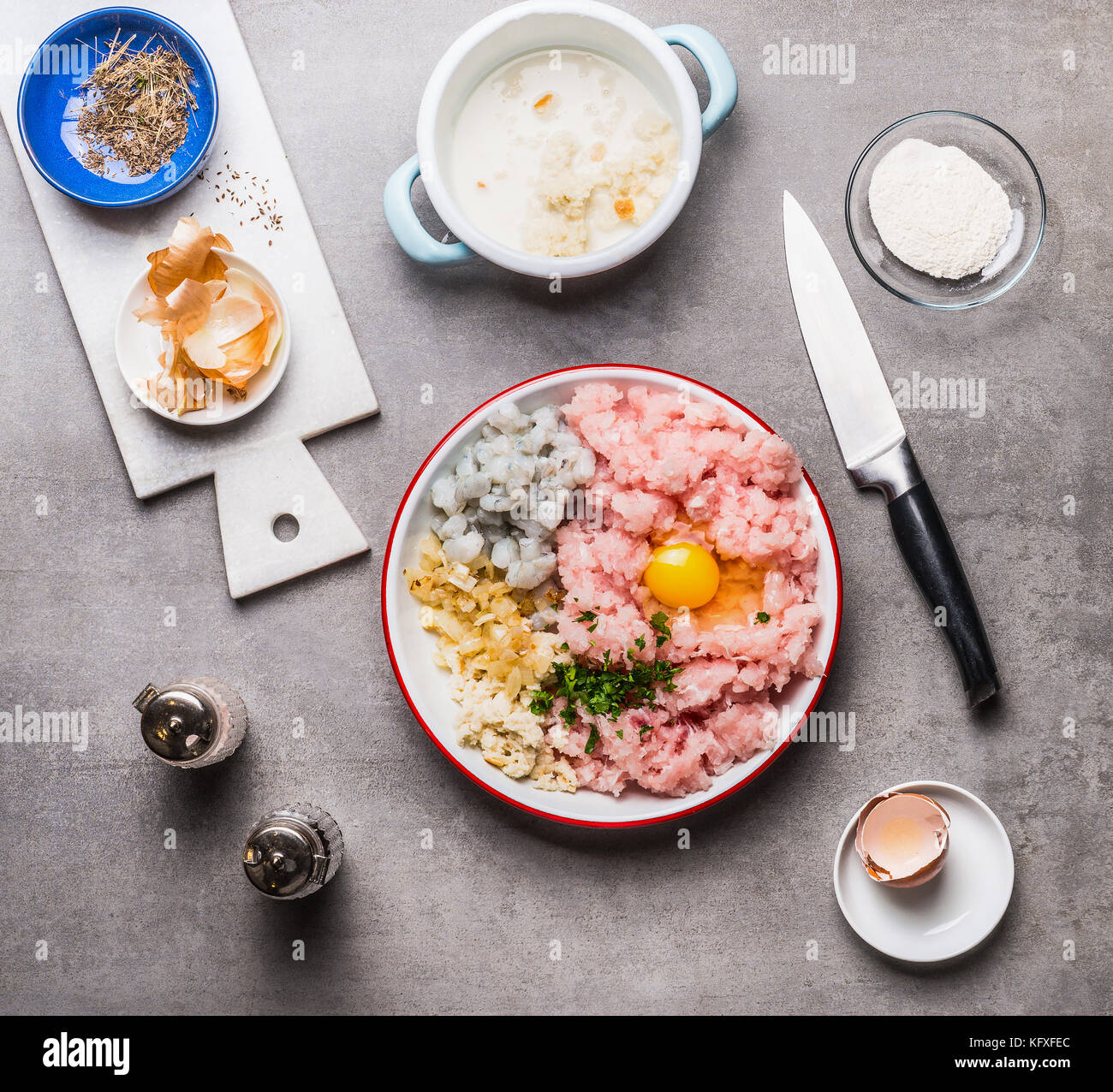 Fish patties making with Minced fish ,egg, shrimps , onion and soaked bread on kitchen table background with knife, top view. Seafood and cooking Stock Photo