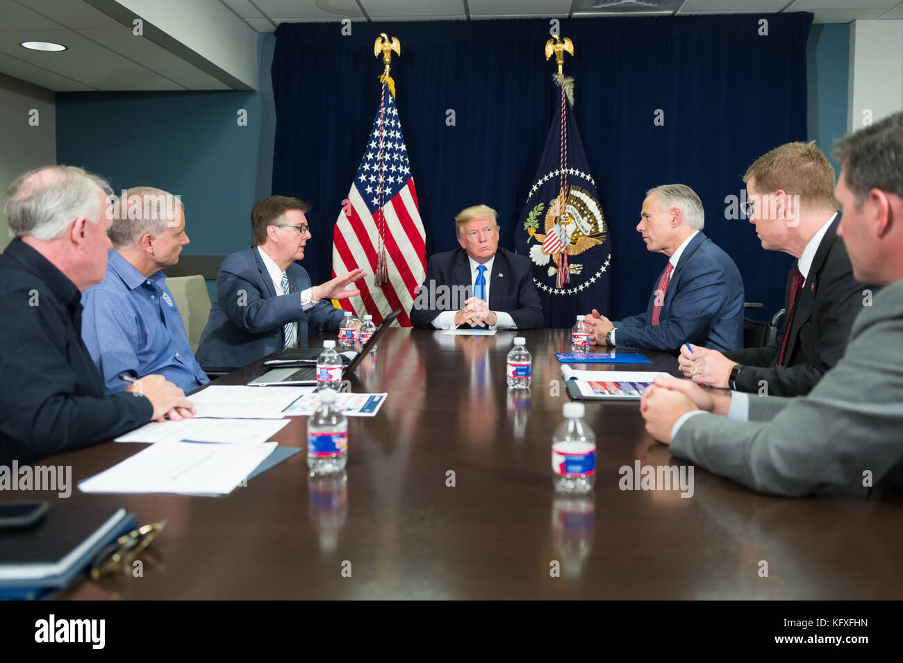 President Donald J. Trump, joined by Texas Gov. Gregg Abbott, Lt. Gov. Dan Patrick and FEMA officials, attends a briefing on the continuing Hurricane Harvey relief and recovery efforts, during a meeting in the Signature Flight Support facility at Dallas Love Field, Wednesday, October 25, 2017, in Dallas, Texas.  Gov. Abbott thanked President Trump for his commitment to Texas.   People:  President Donald J. Trump  Transmission Ref:  MNC  Hoo-Me.com / MediaPunch Stock Photo