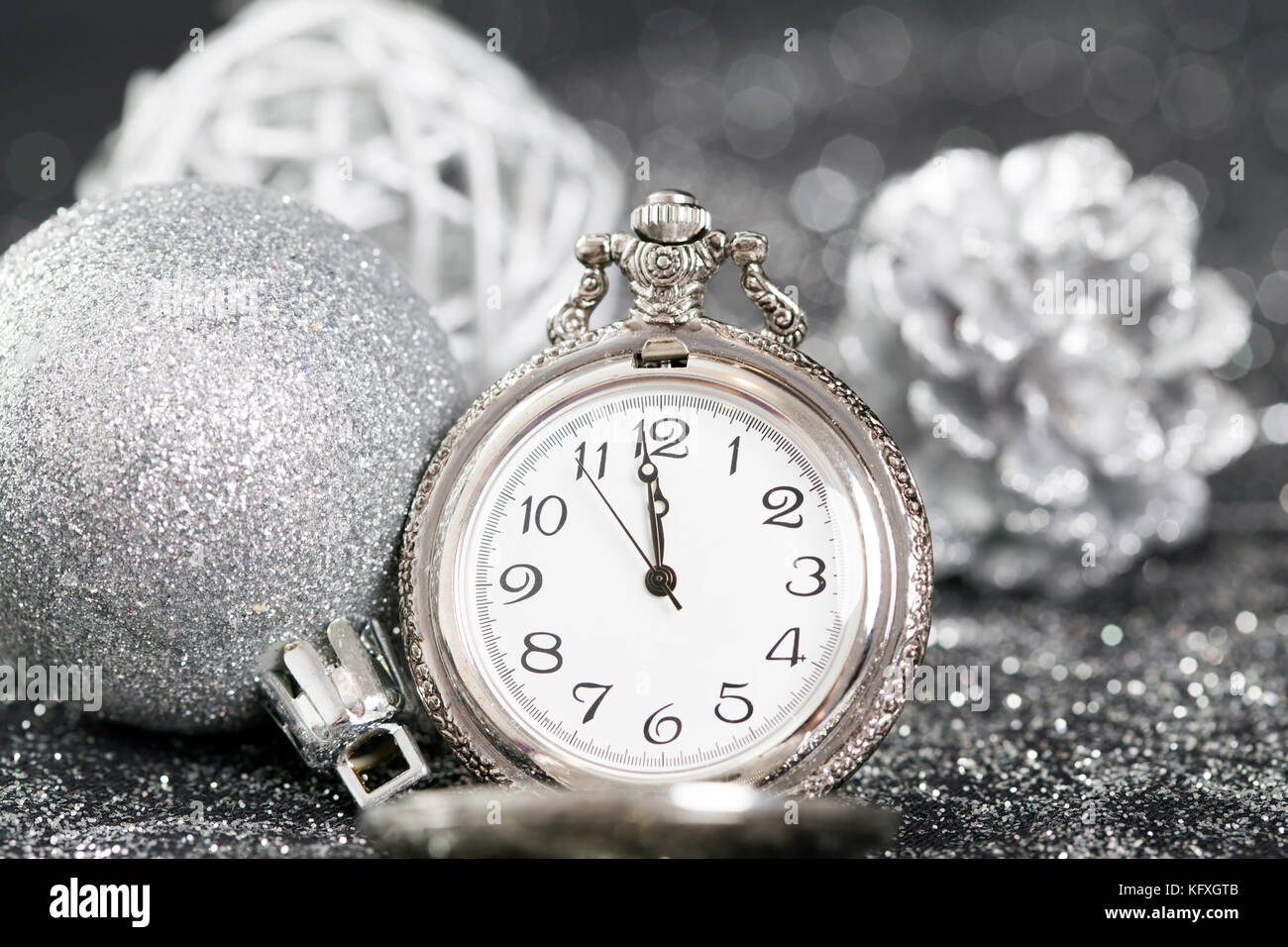 New Year's at midnight - Old pocket watch on silver background Stock ...
