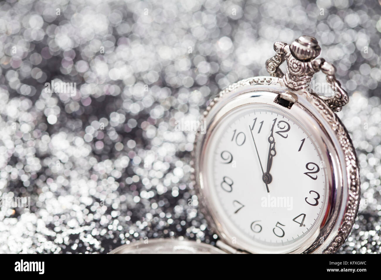 New Year's at midnight - Old pocket watch on silver background Stock ...