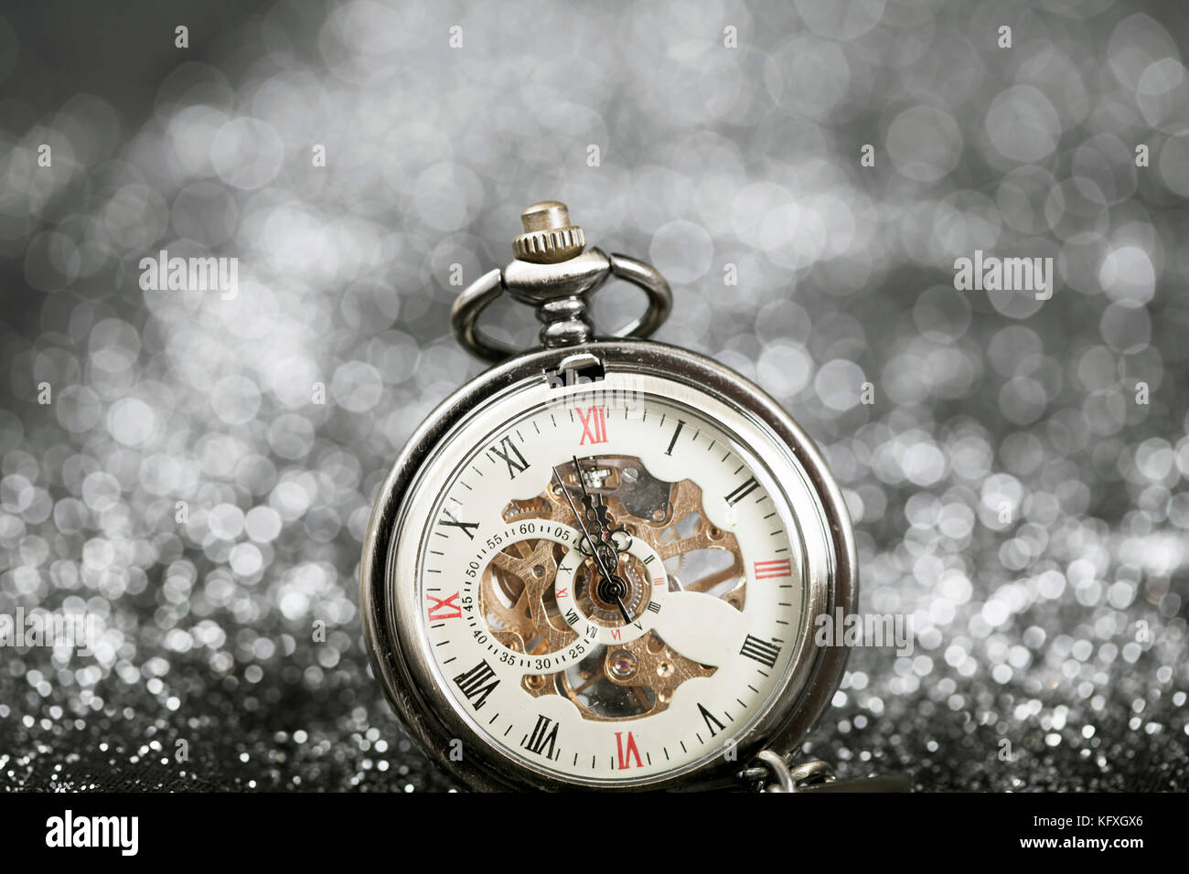 New Year's at midnight - Old pocket watch on silver background Stock ...