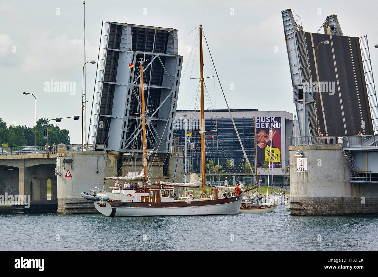 Sonderborg, Denmark - July 5th, 2012 - Traditional two-masted sailing ship passing the opened King Christian X drawbridge in downtown Sonderborg Stock Photo