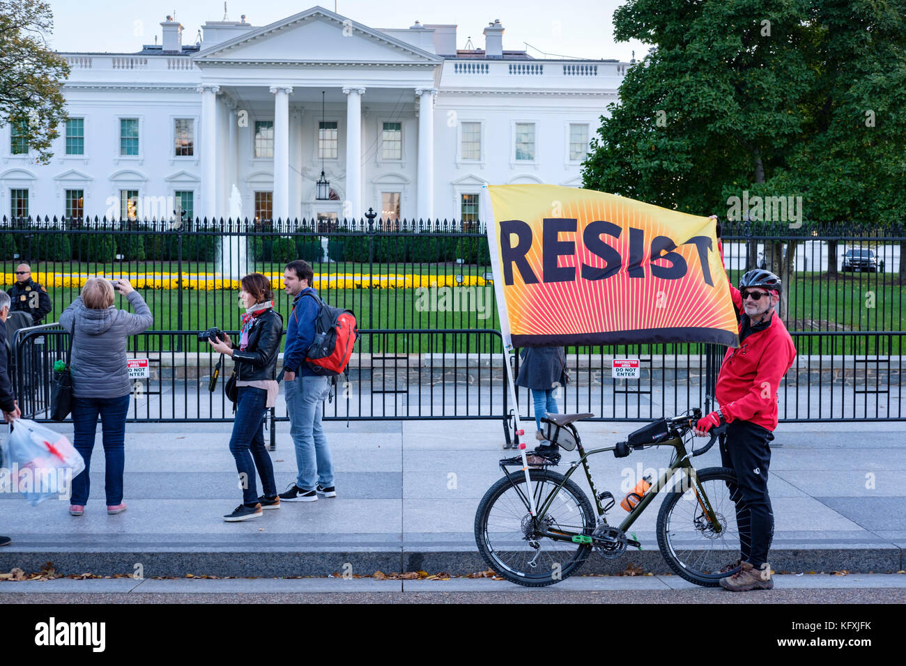 Anti-Trump resistance protester in front of the White House holding a Resist banner/flag, protesting against president Trump, Washington, DC, USA. Stock Photo