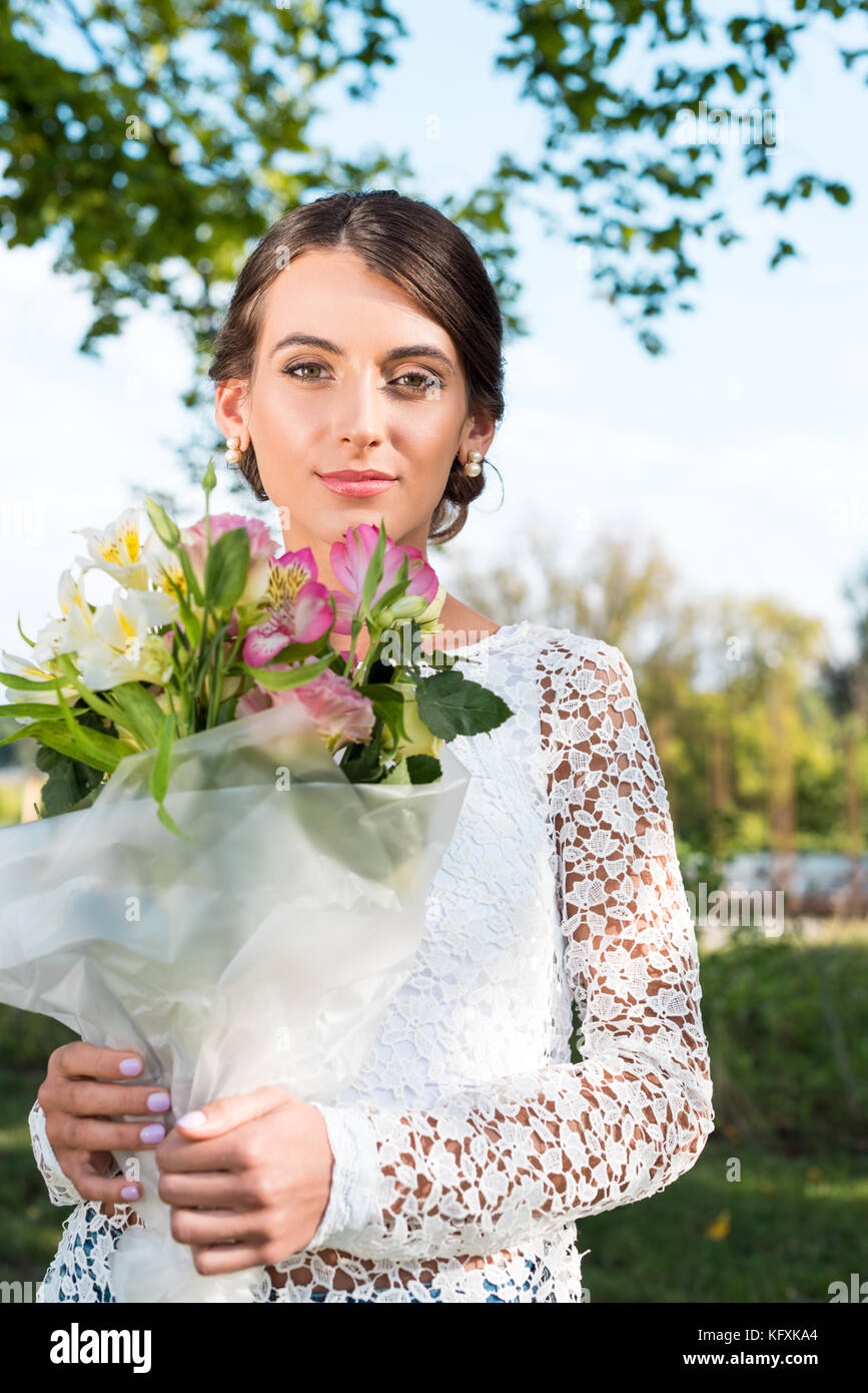 beautiful woman with bouquet of flowers Stock Photo - Alamy