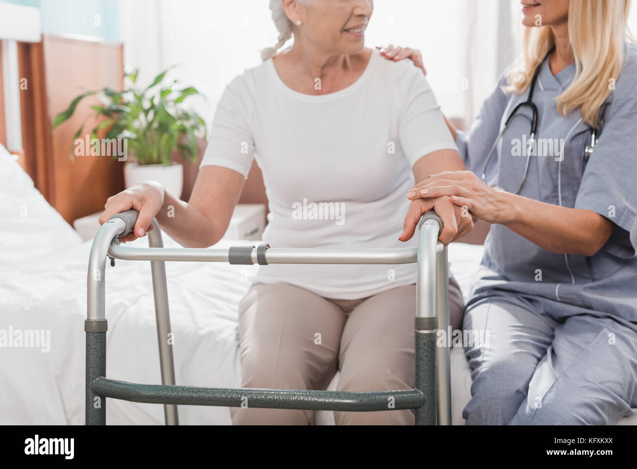 nurse and senior patient with walker Stock Photo - Alamy
