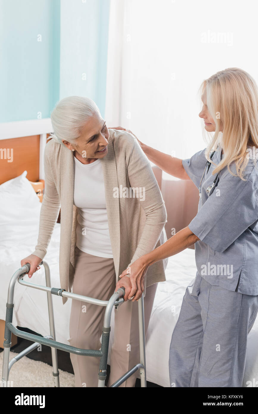 nurse and senior patient with walker Stock Photo Alamy