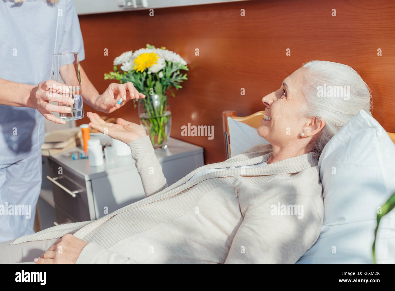 nurse giving medicine to senior patient Stock Photo Alamy