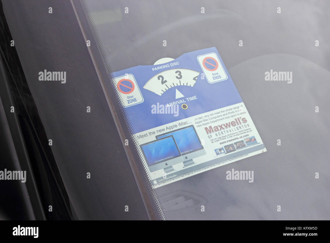 https://c8.alamy.com/comp/KFXM5D/parking-disc-being-displayed-in-car-windscreen-KFXM5D.jpg