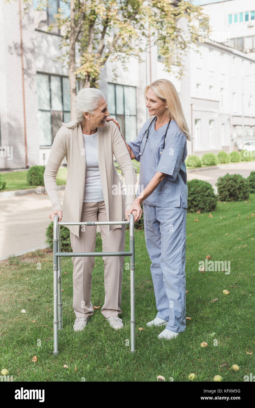 nurse and senior patient with walker Stock Photo Alamy