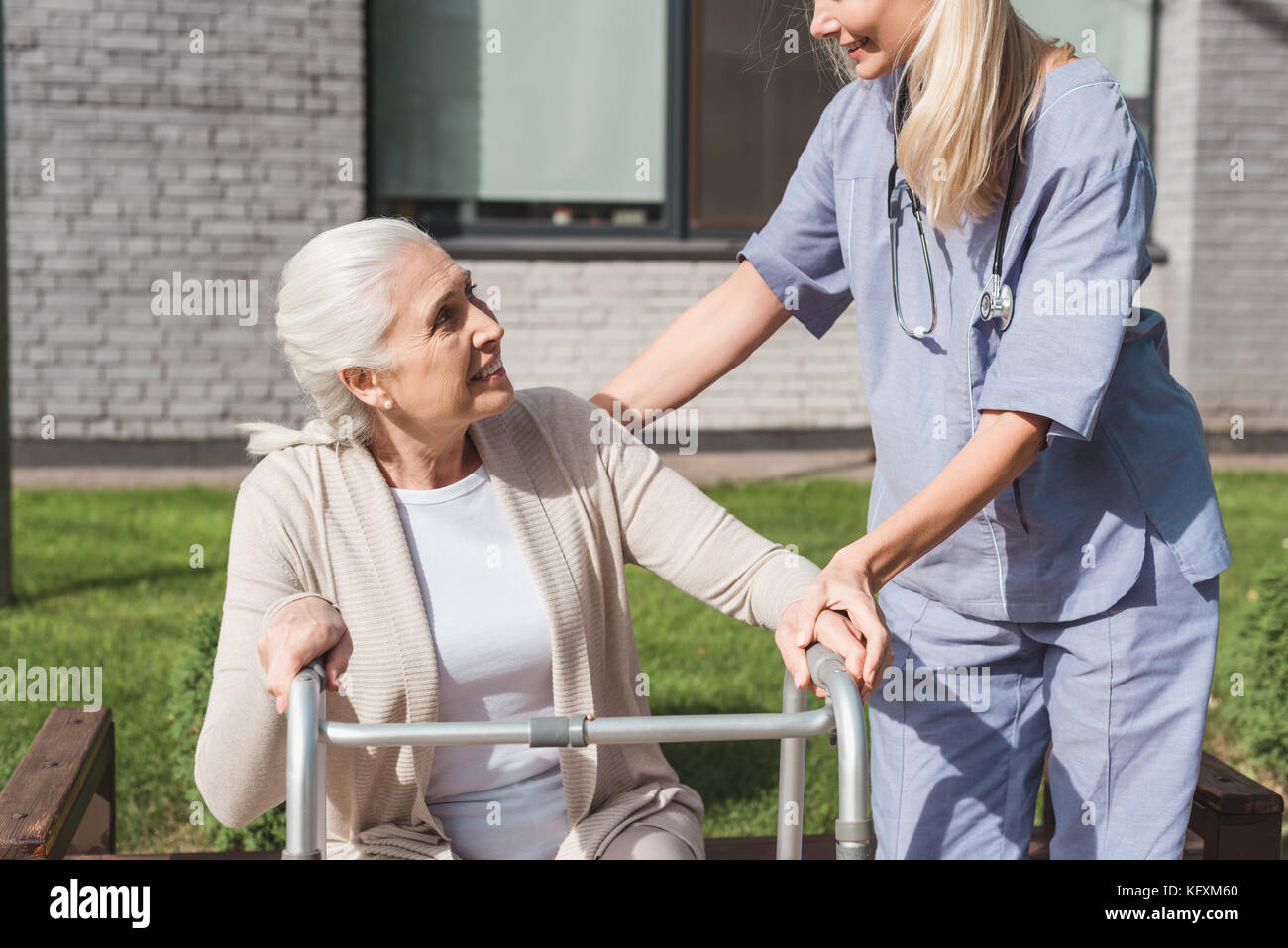 nurse and senior patient with walker Stock Photo Alamy