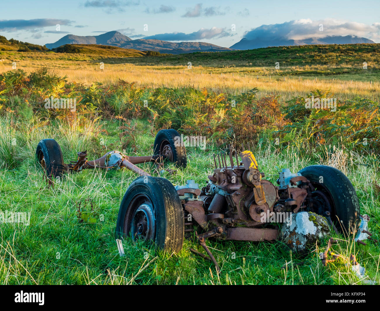 Car wreck on sheep pasture near Portree, Isle of Skye National Park, Scotland, Great Britain Stock Photo