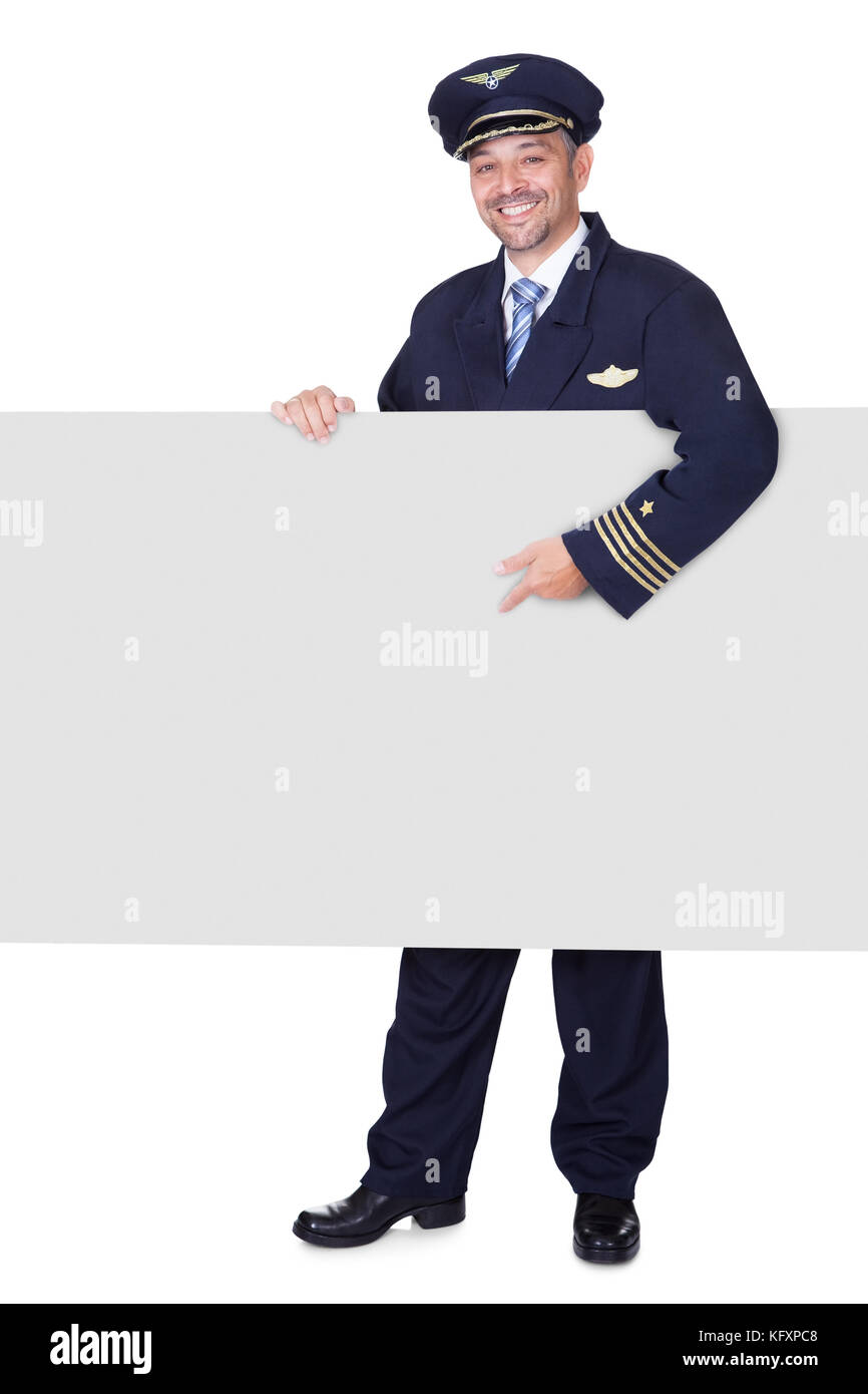 Portrait Of Happy Pilot Holding Blank Placard On White Background Stock Photo